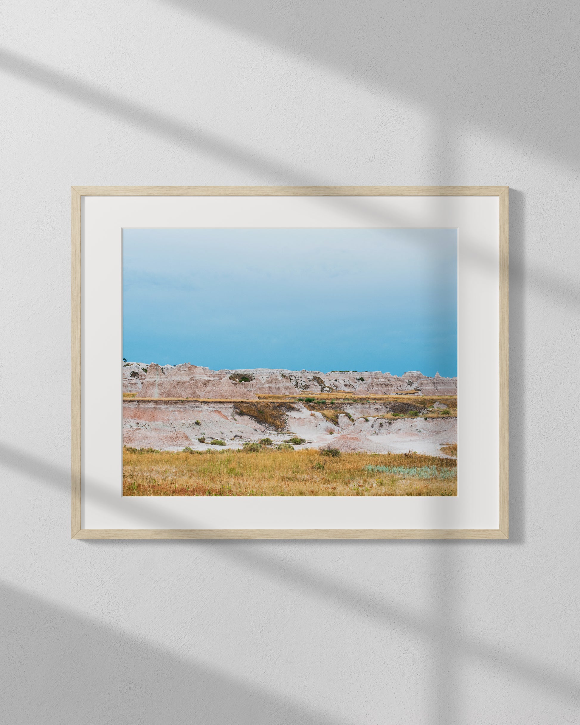 Framed photograph of a landscape with a clear blue sky and natural scenery.