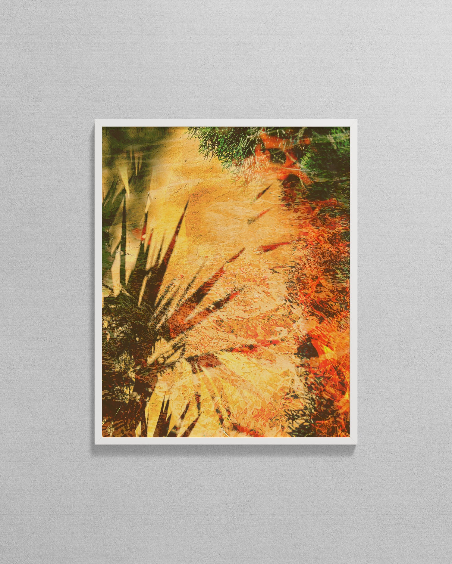 Framed abstract artwork with warm colors on a gray wall