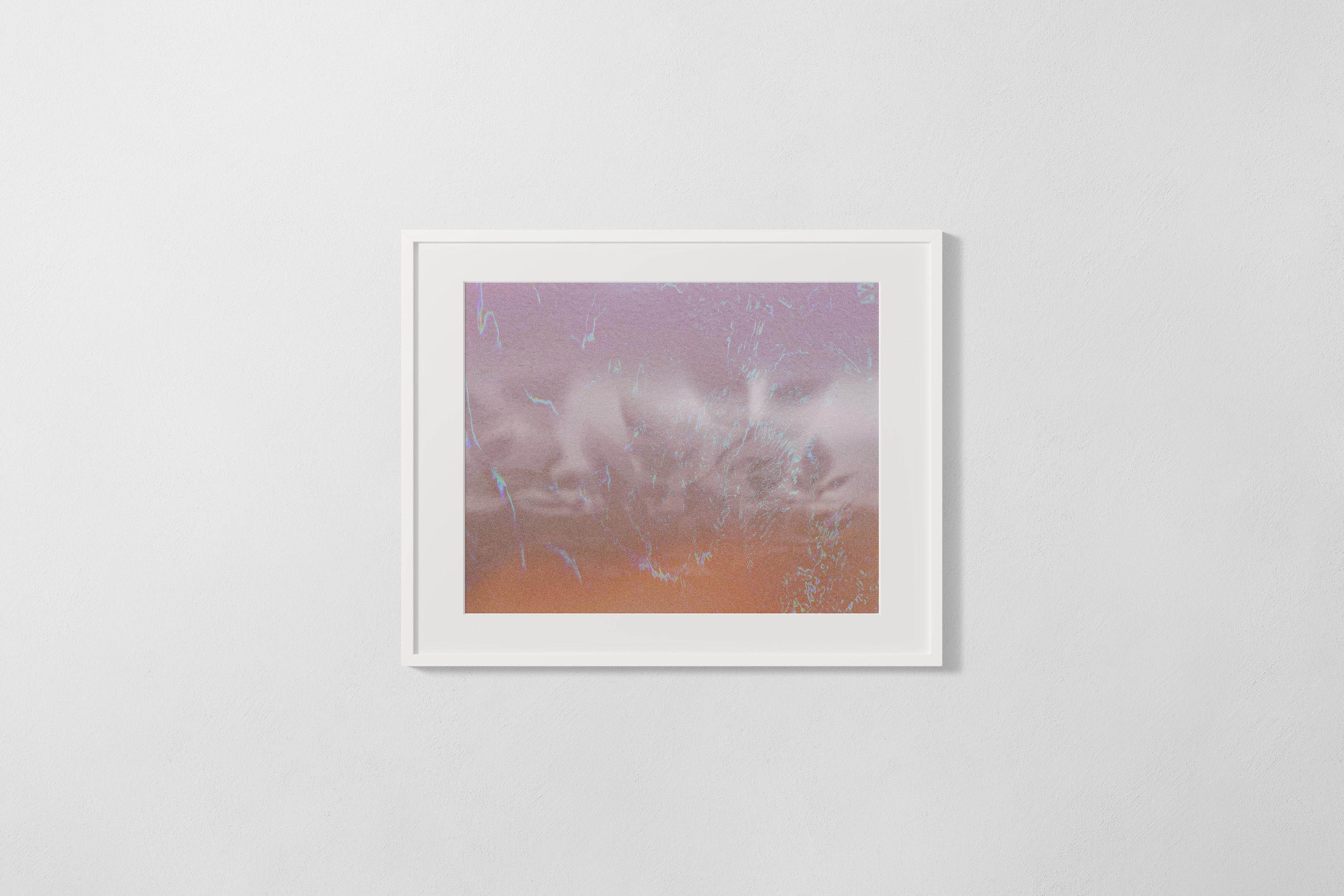 Framed artwork with a gradient from purple to orange on a white wall