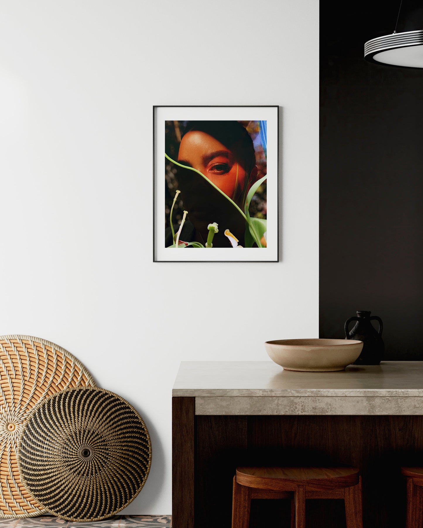 Framed artwork on a wall above a table with decorative items.